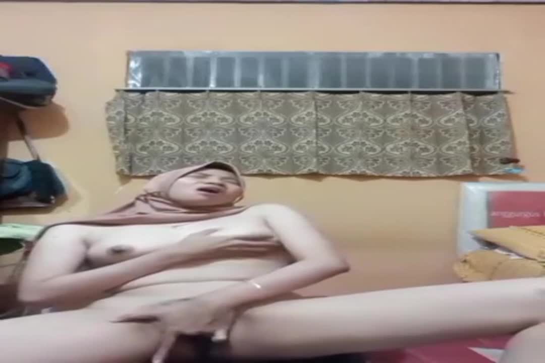A petite girl from Indonesia-Malaysia is feeling very aroused and is masturbating.
