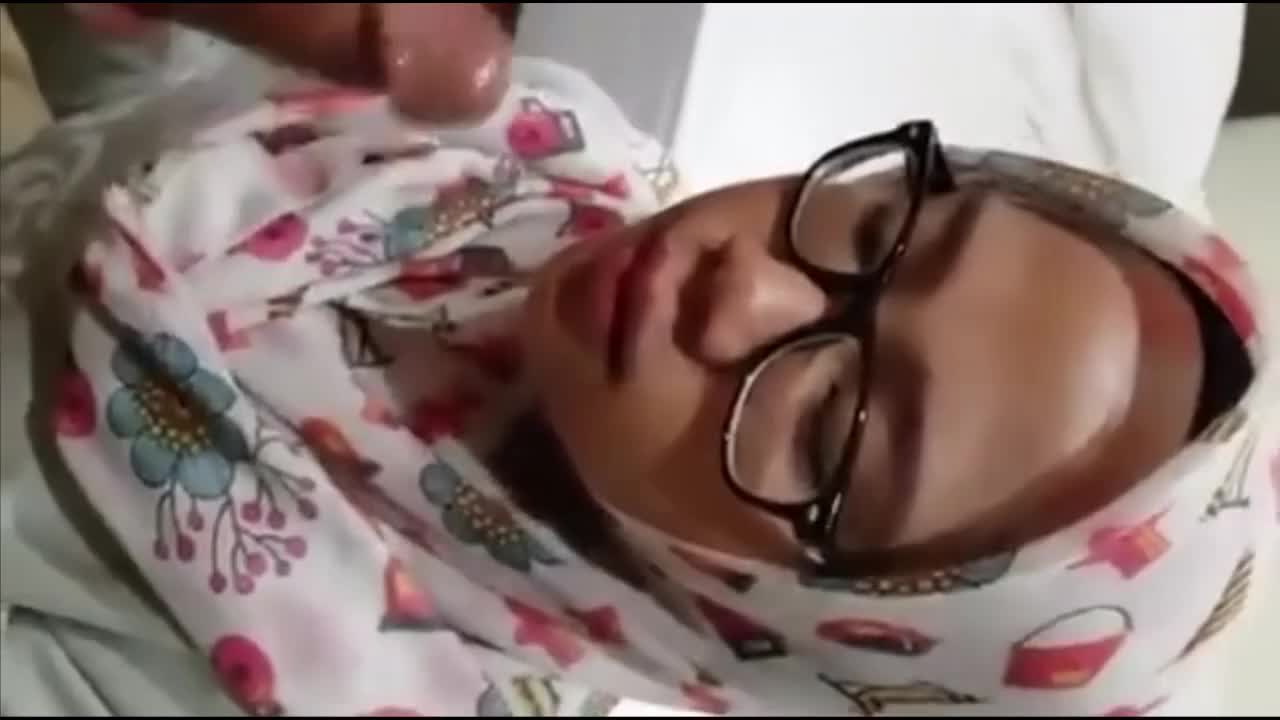 A Muslim girl wearing a hijab is performing oral sex and receiving ejaculation.